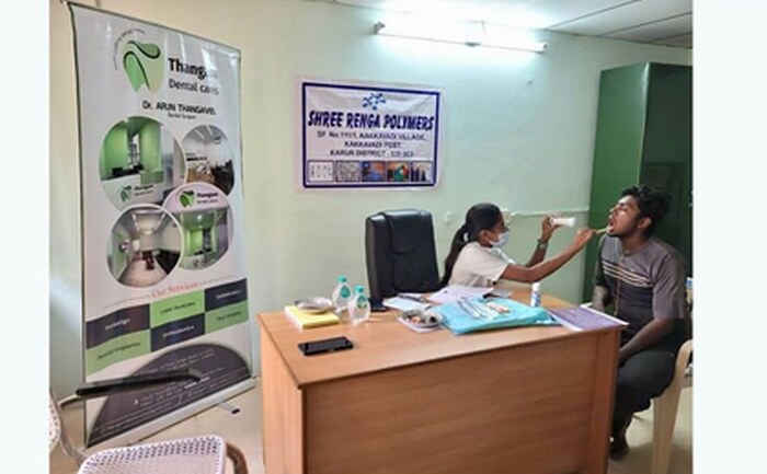 A dentist examines a patient at an SRP Foundation dental camp at the Puliyur unit.
