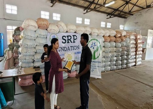 SRP Foundation representatives recognise a partner at a recycling facility.