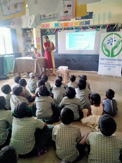 Children sit on the floor of a government school classroom during an SRP Foundation education session.