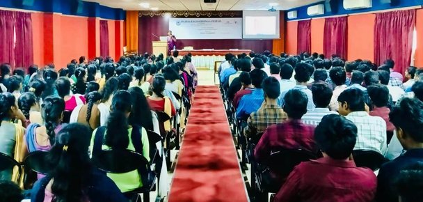 A large audience attends an SRP Foundation women's awareness session in an auditorium.